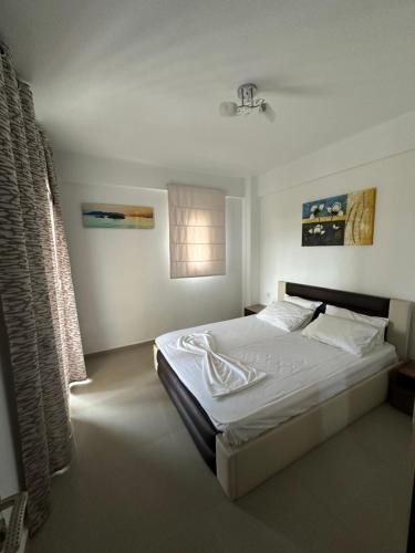 ein Schlafzimmer mit einem großen Bett mit weißer Bettwäsche in der Unterkunft Villa Spartandom in Gerakini