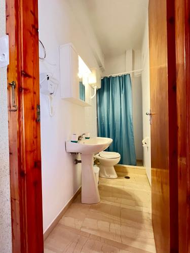 a bathroom with a sink and a toilet at Oelia Rooms & Apartments in Agia Marina Aegina
