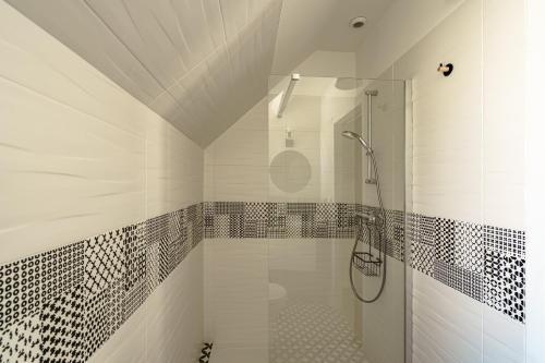 une salle de bain avec une douche avec une porte vitrée dans l'établissement Ty Marok - Maison pour 5 proche plage, à Douarnenez