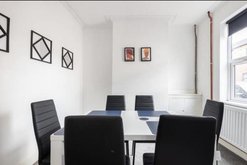 a meeting room with a table and chairs at Home Away From Home Local To A Lot Of Amenities in Stoke on Trent