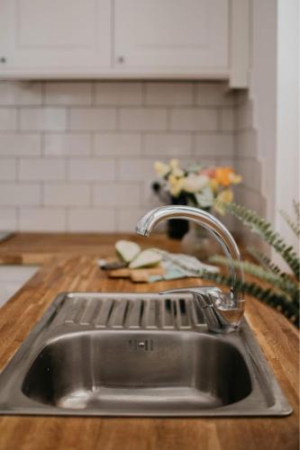 a kitchen sink with a faucet on a counter at Green House Relax in Płaska
