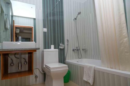 a bathroom with a toilet and a shower and a sink at Mount View Pokhara in Pokhara