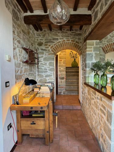 an office with a wooden desk in a stone wall at Bio Agriturismo Il Vigno in Caprese Michelangelo
