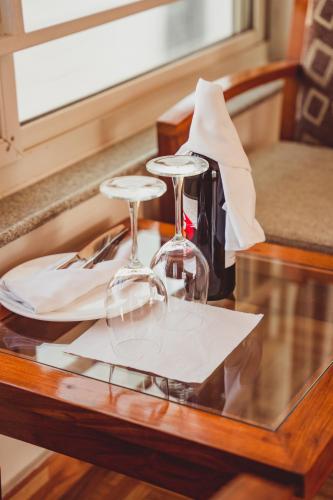 a table with two wine glasses on top of it at Mount View Pokhara in Pokhara