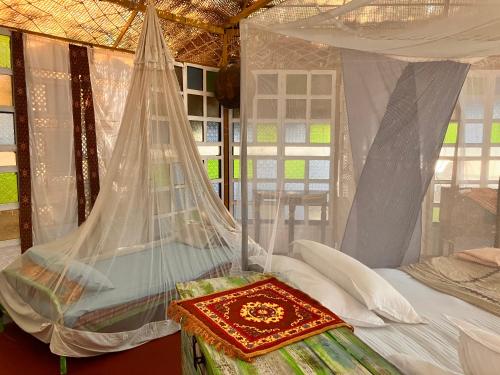 a bedroom with a bed with a mosquito net at Cozy Nook Goa Palolem in Palolem