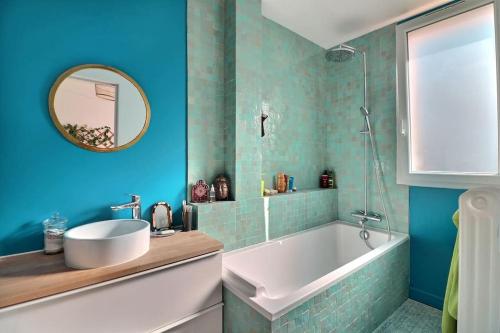 une salle de bain avec une baignoire, un lavabo et un miroir dans l'établissement Charming 2 bedrooms ideal for Olympic Games Paris!, à Boulogne-Billancourt