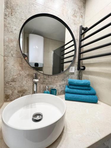 a bathroom with a white sink and a mirror at Seahorse apartment in Liepāja