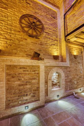 a room with a brick wall with a clock on the wall at Mahhsen Mansion Oldcity in Istanbul