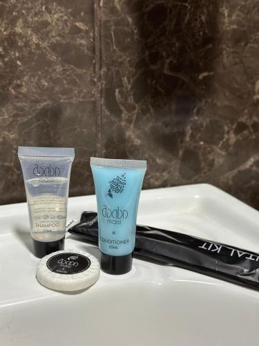 two products sitting on top of a white sink at Guest house chavchavadze N23 in Stepantsminda