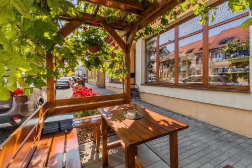a wooden bench sitting outside of a building at Apartmán Solaris in Kyjov