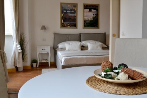 a room with a bed and a table with a bowl of food at LE QUATTRO MURA EXCLUSIVE in Florence