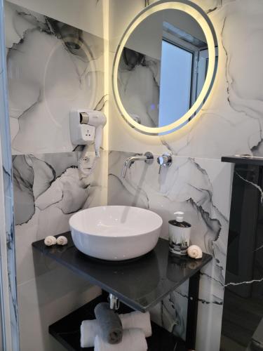 a bathroom with a sink and a mirror at Villa Crystal in Sarandë