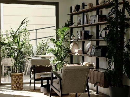 a room with plants and a table and chairs at Bond Smart Living Suites in Athens