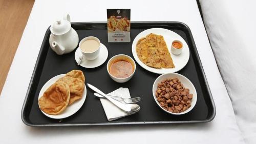a tray with breakfast foods on a table at Hotel de elaaf in Srinagar