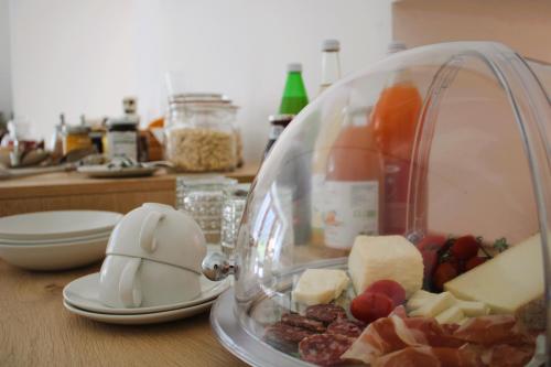 a food processor filled with cheese and other foods at B&B Ca' Serena wine retreat in Ledro