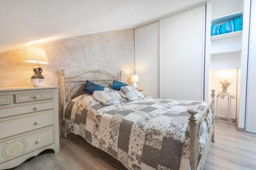 a bedroom with a bed and a dresser at Residence naturiste Eden in Leucate