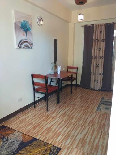 a dining room with a table and two chairs at golden anchor lodge in Coron
