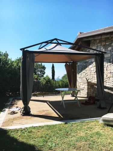 a canopy over a picnic table in a yard at 2PoggioValentine Mansion Nature in Scansano