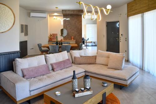 a living room with a couch and a table at Terra Nova Luxury Villa in Mystras