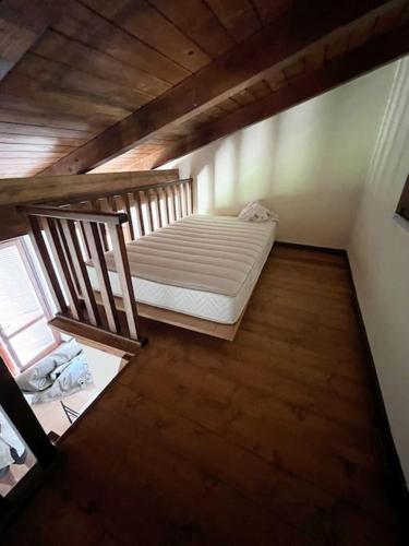 a attic room with a bed and a wooden floor at 2PoggioValentine Mansion Nature in Scansano