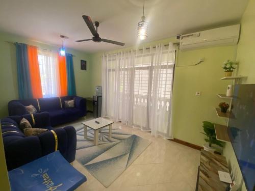 a living room with a couch and a table at Modern 1-Bedroom Apartment with AC & Parking along Mtwapa Beach Road in Mtwapa