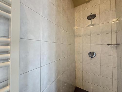 a bathroom with a shower with white tile at De Eikhoeve - Alveringem in Alveringem