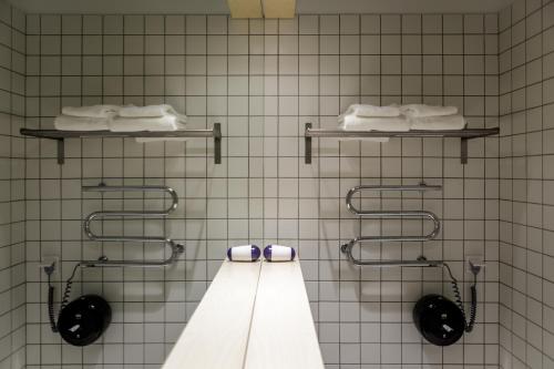 a bathroom with two toilets and towels on the wall at Melt in Palanga in Palanga