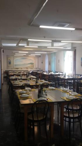 a large room with many tables and chairs at Casa Valdese di Vallecrosia Al Mare in Vallecrosia