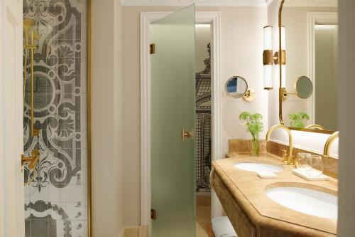 a bathroom with two sinks and a shower at The Westin Palace, Madrid in Madrid