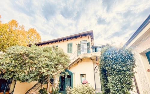 a white house with a balcony on top of it at Le Residenze dei Serravallo in Trieste