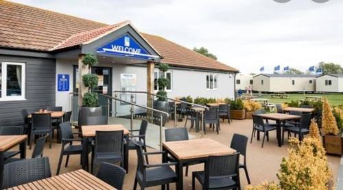 a patio of a restaurant with tables and chairs at Seaview Holiday Rentals - Seawall in Whitstable