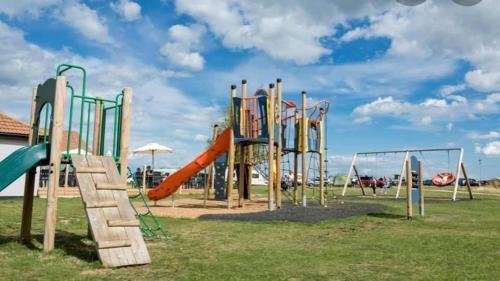 an empty playground with a slide and slides at Seaview Holiday Rentals - Seawall in Whitstable