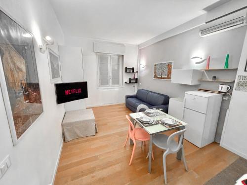a small living room with a table and a kitchen at Free Parking - Monolocale sul Naviglio in Milan
