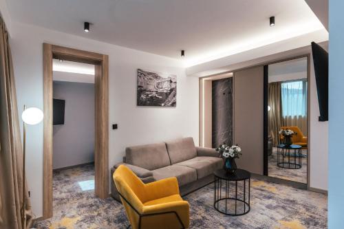 a living room with a couch and a chair at City Hotel Dubrovnik in Dubrovnik