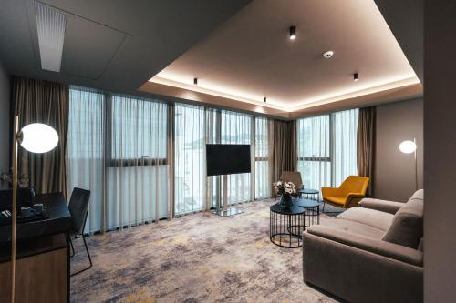 a large living room with a couch and a tv at City Hotel Dubrovnik in Dubrovnik