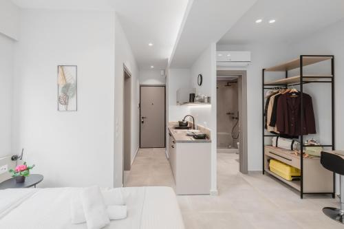 a white kitchen with a sink and a counter top at ELA FIVE RESIDENCES in Athens