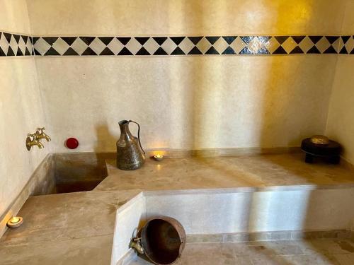 a bathroom with a sink with a vase on it at Riad Ta'achchaqa in Marrakesh