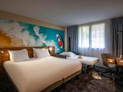 a hotel room with two beds and a map on the wall at Novotel Antibes Sophia Antipolis in Valbonne