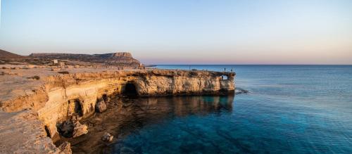 an aerial view of the ocean and a cliff at Love Bridge Seaview Villas in Ayia Napa