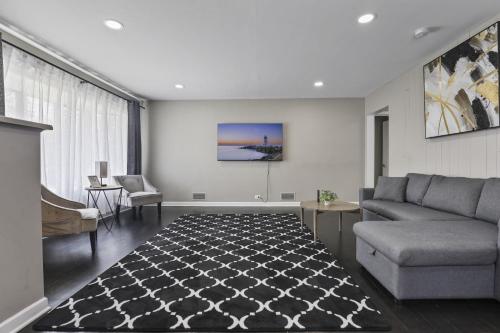 a living room with a couch and a table at Charming Retreat in the Heart of Des Plaines residence in Des Plaines