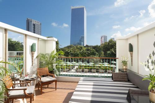 an apartment balcony with a view of the city at The Sukhothai Bangkok in Bangkok