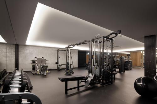 a gym with a lot of equipment in a room at Hotel Apartamento Dunamar in Monte Gordo