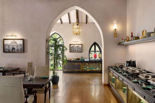 an archway in a kitchen with a counter and a table at Ramada by Wyndham Goa Vagator in Vagator