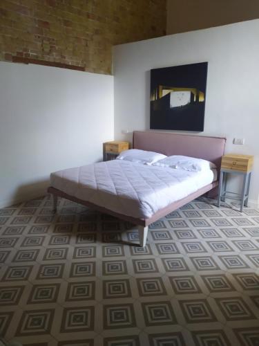 a bedroom with a large bed and a carpet at Masseria Celentano Relais & Agriturismo in San Severo