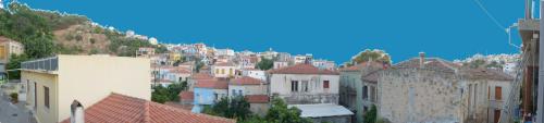 a group of buildings on a hill with houses at Soultana's Antique House in Plomarion