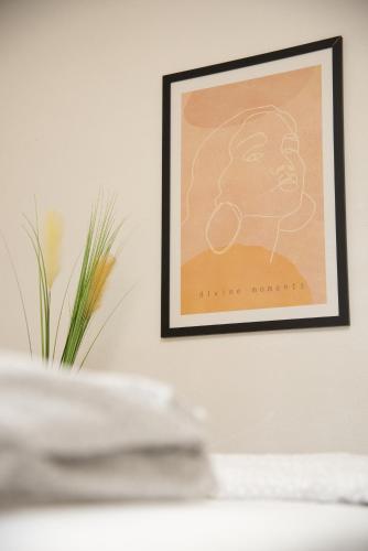 a picture frame hanging on a wall with a table at geräumige Ferienwohnung mit Terrasse in Kirchberg an der Jagst