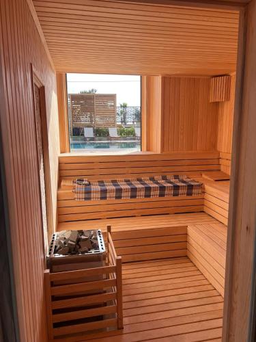 a sauna with a window and two beds in it at Ulu Panorama Residence in Alanya