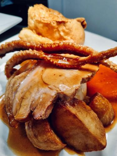 a plate of food with meat and french fries at The Reindeer Inn in Sandtoft
