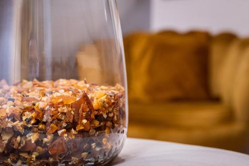 a glass jar filled with food sitting on a table at Pokoje, Noclegi, Apartamenty Dune Resort Łeba in Łeba