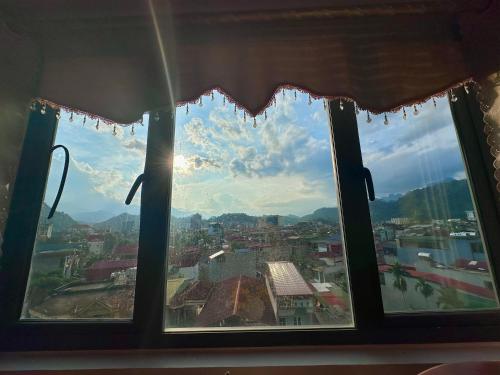 une fenêtre avec vue sur la ville dans l'établissement Tam Giác Mạch Hotel, à Ha Giang